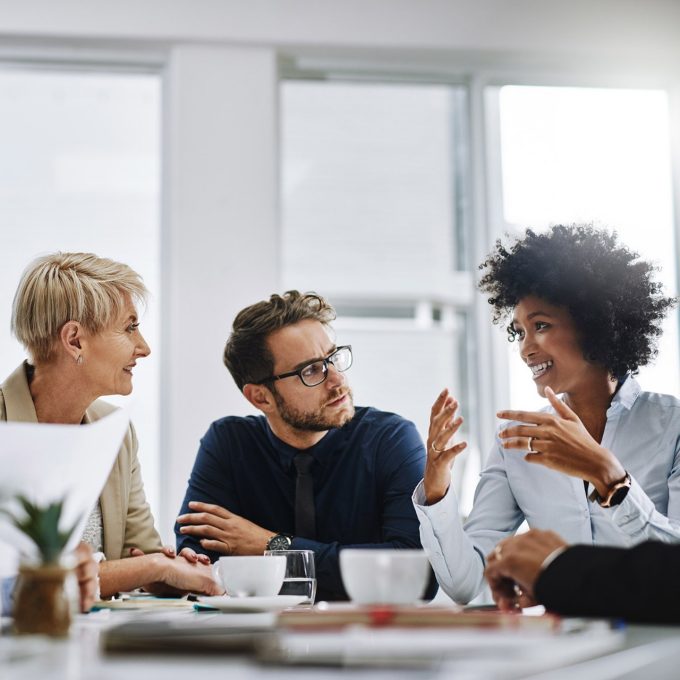 Shot of a group of business people sitting together in a meeting