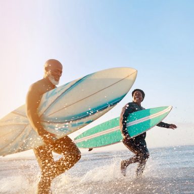 Shot of a mature couple surfing at the beach