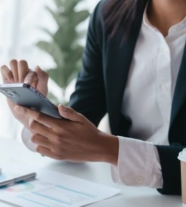 Using mobile cellphone, Close up hands of asian bookkeeper female working with stack of papers and balance sheet with bureaucracy hardworking in office desk.