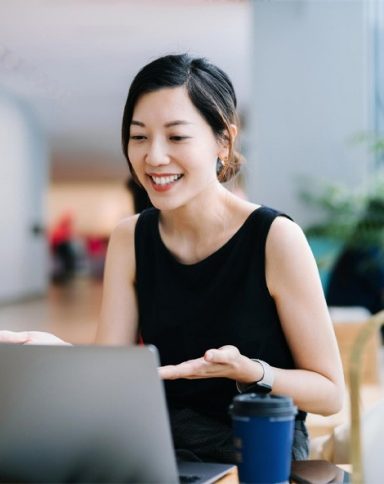 Smiling professional young businesswoman talking in front of the camera