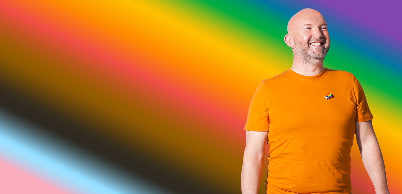 Smiling man on a rainbow background image 1916x928