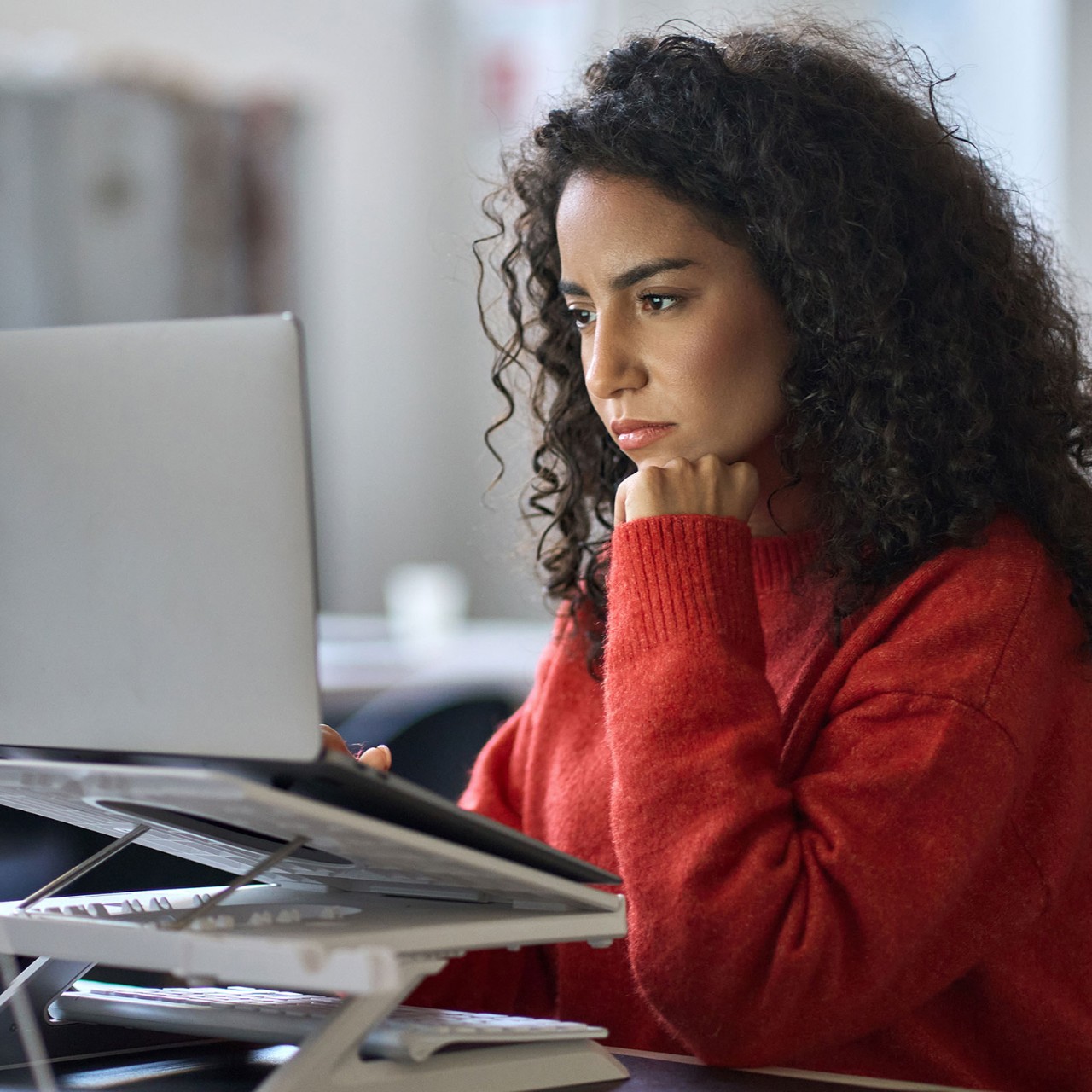 Woman at her desk working on a laptop