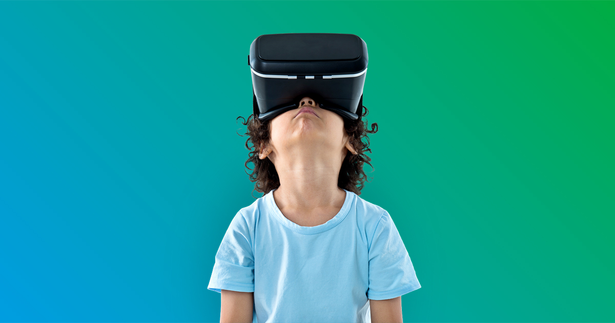 Little boy with a virtual reality game isolated on gradient green background