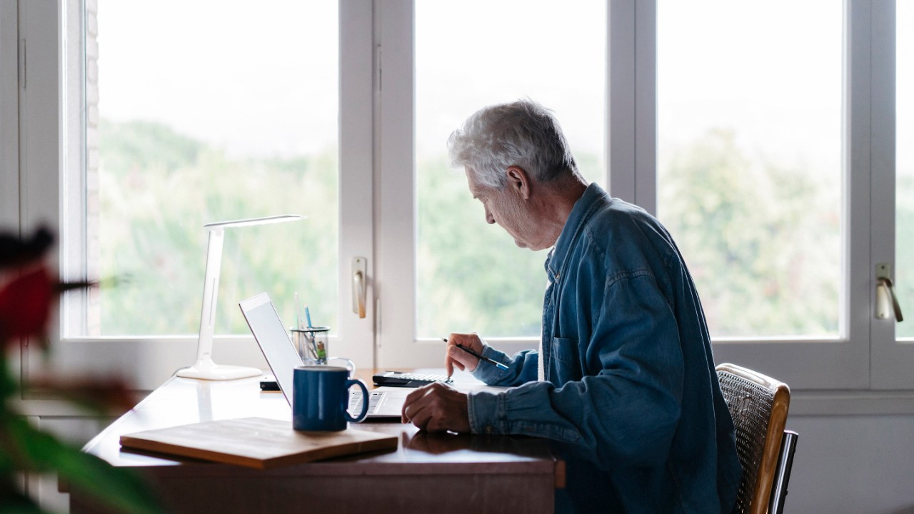 older man checking his financial accounts