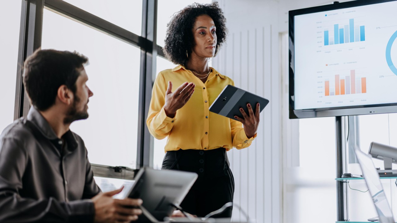 Business woman presenting financial result holding digital tablet