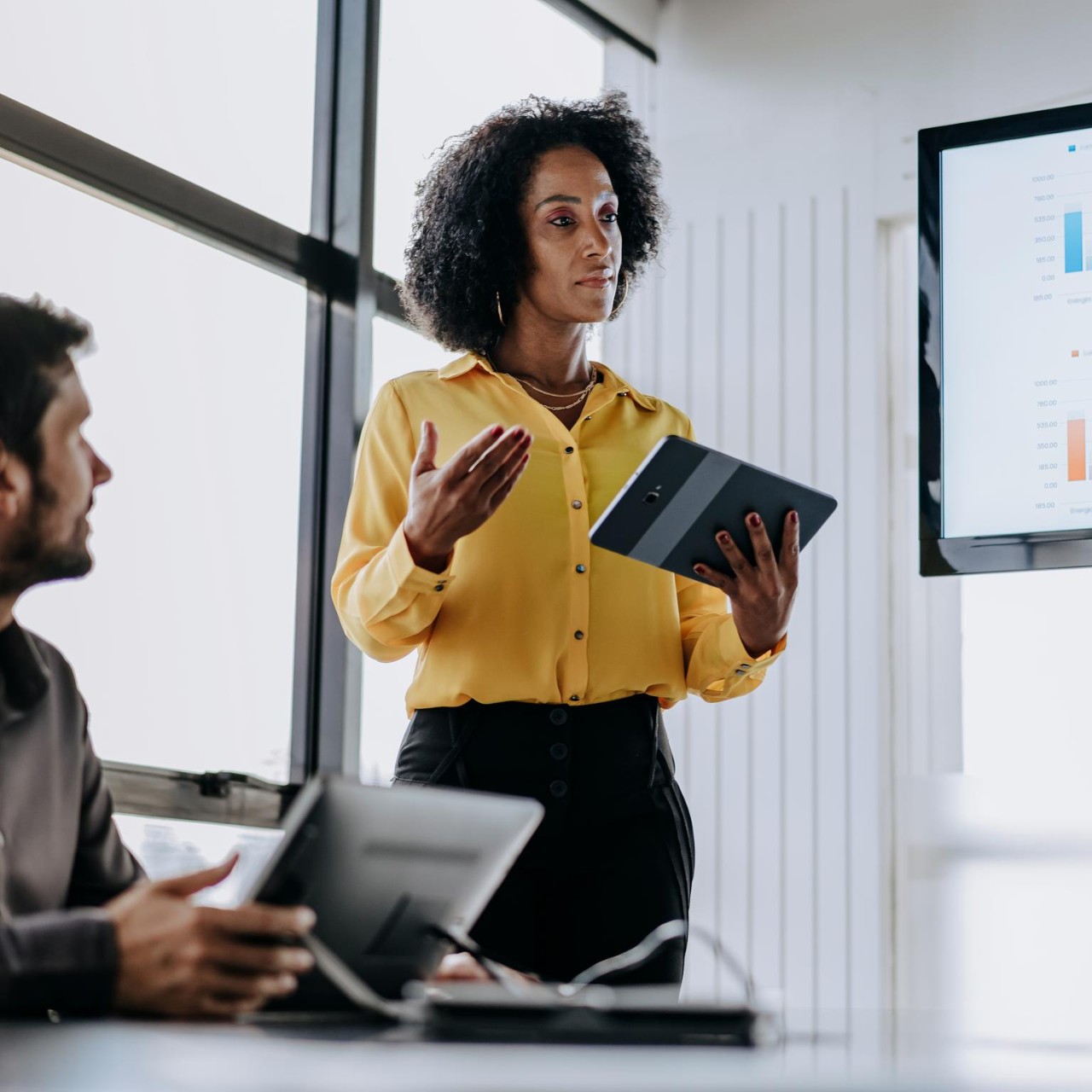 Business woman presenting financial result holding digital tablet