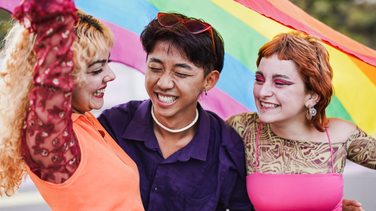 Young diverse people having fun at LGBT pride parade