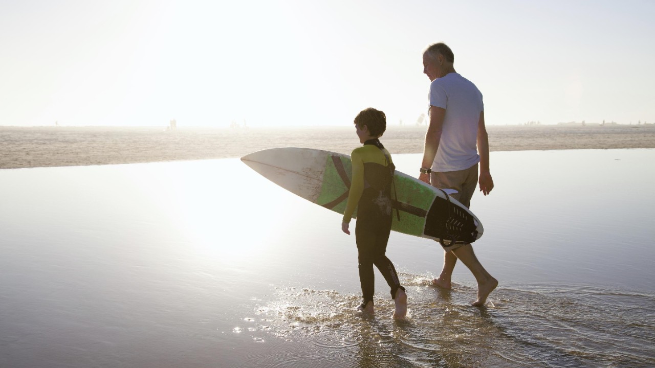 father and son with surfing board